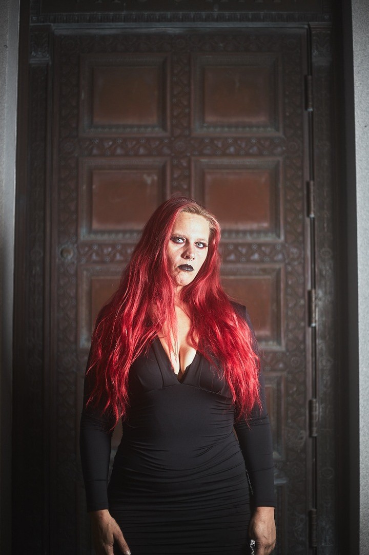 Starrgazzee posing in front of a large wooden door