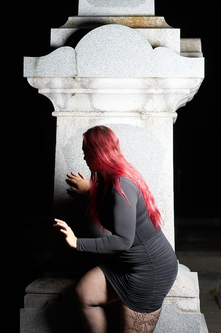 Starrgazzee posed beside a white stone monument