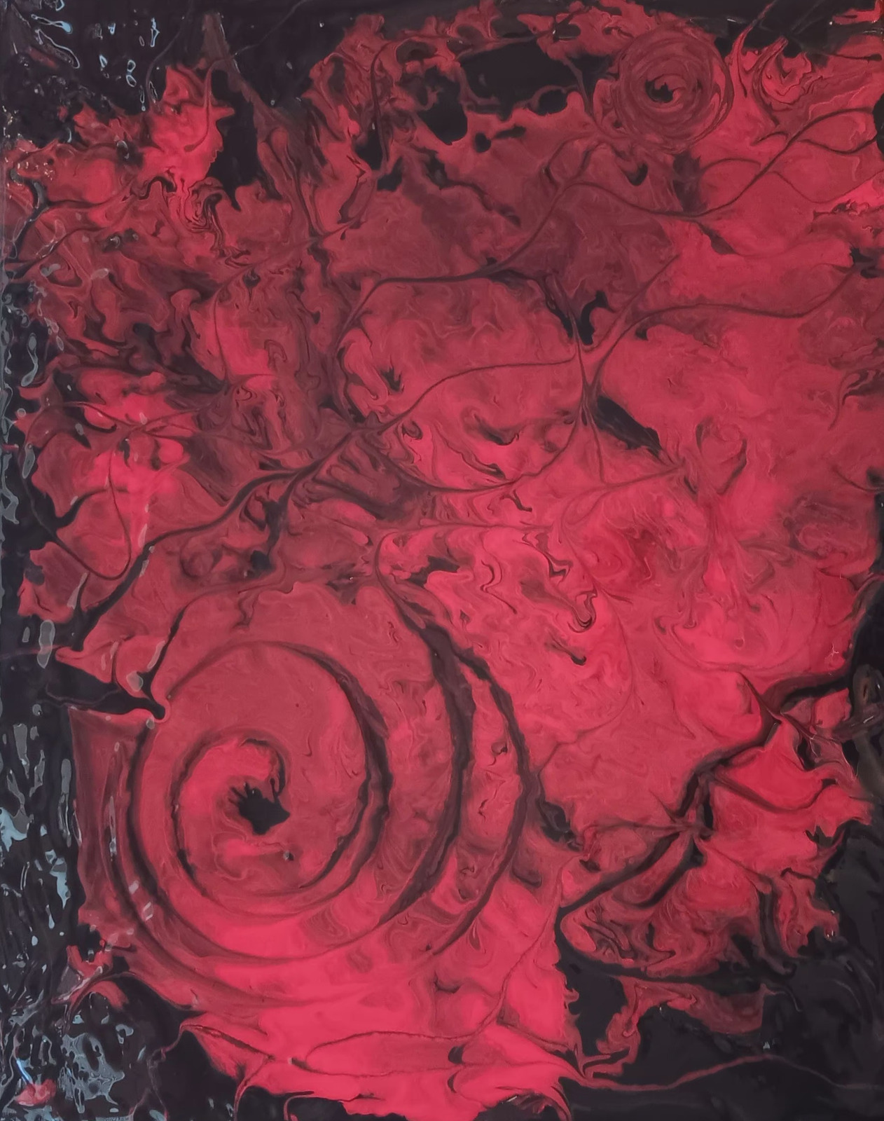 Red and black swirling marbled painting