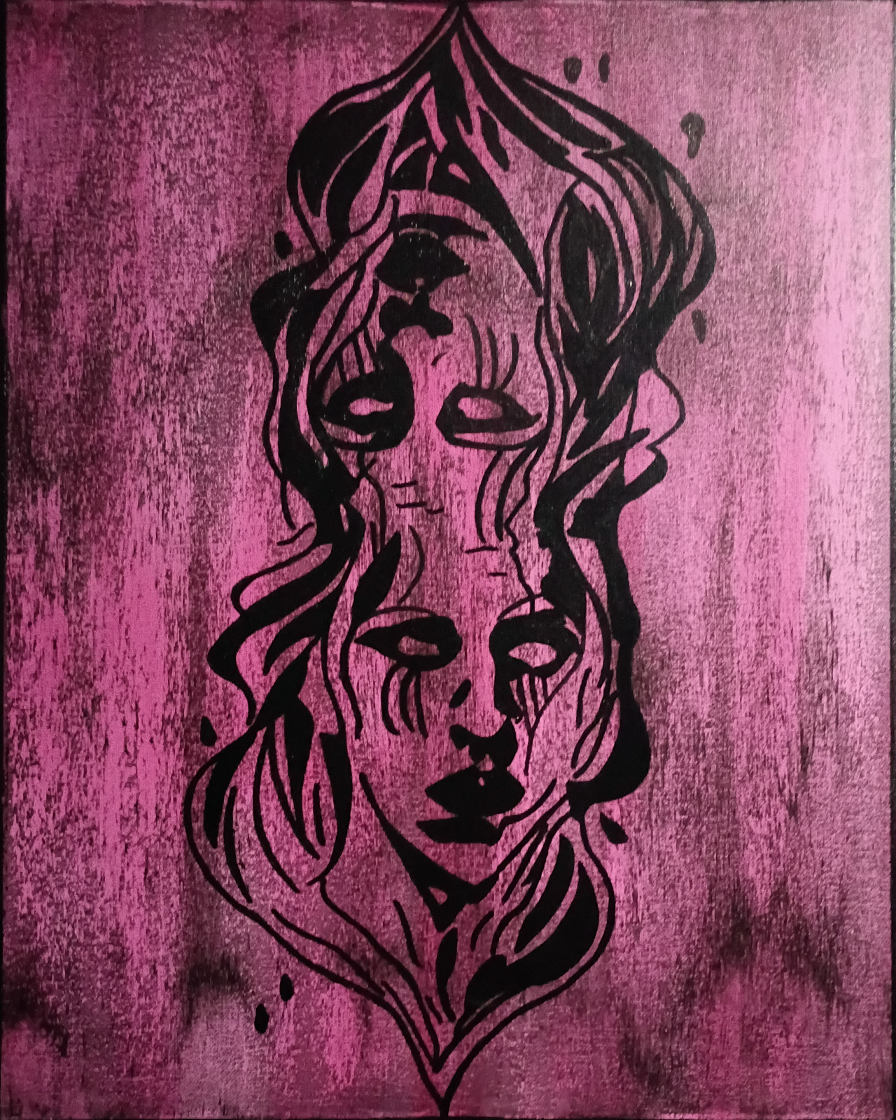 Two opposing faces painted in black on a pink canvas