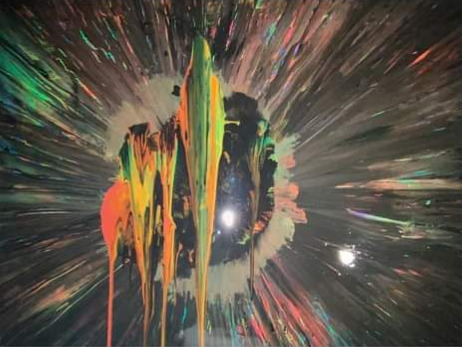 Bright dripped paint surrounded by radiating multicolored streaks on black