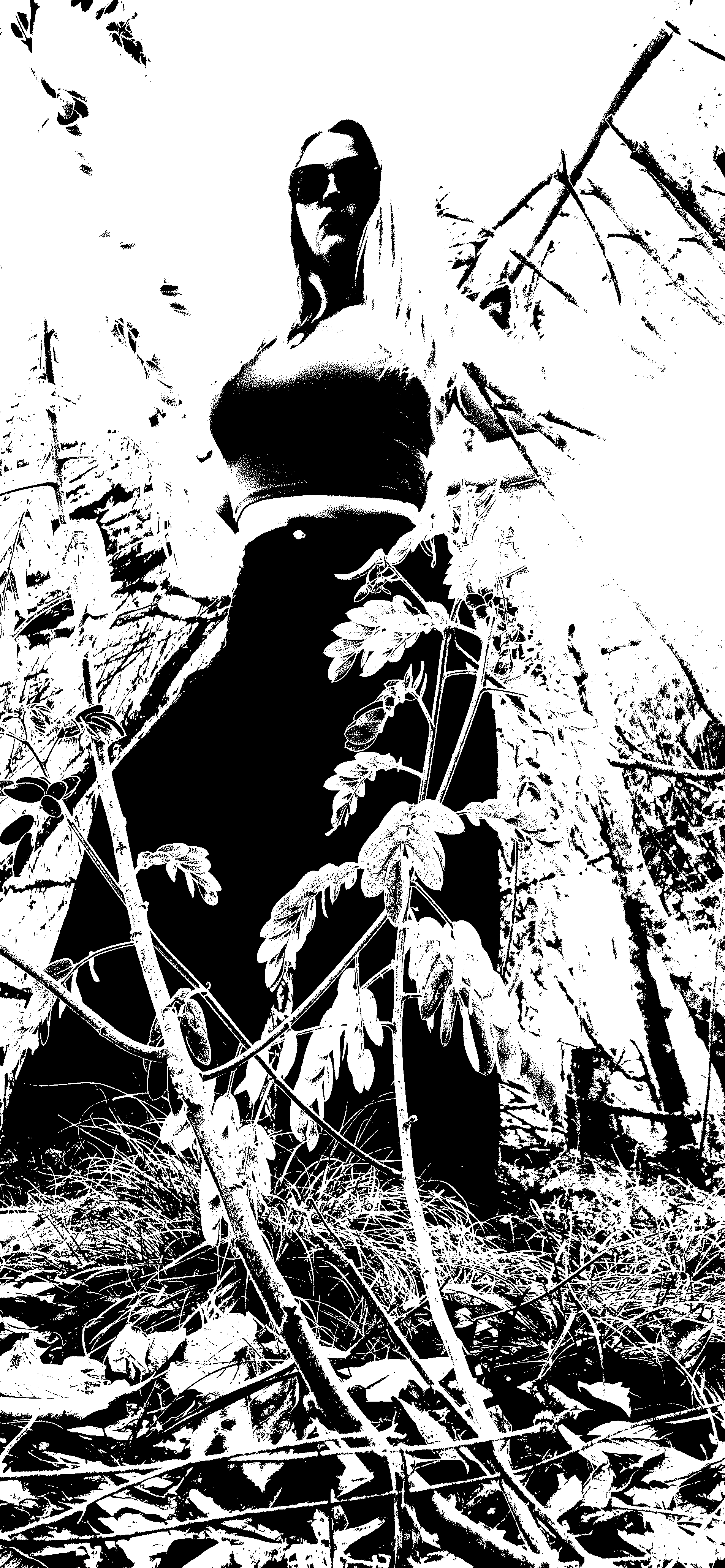 Figure framed by tall wild plants