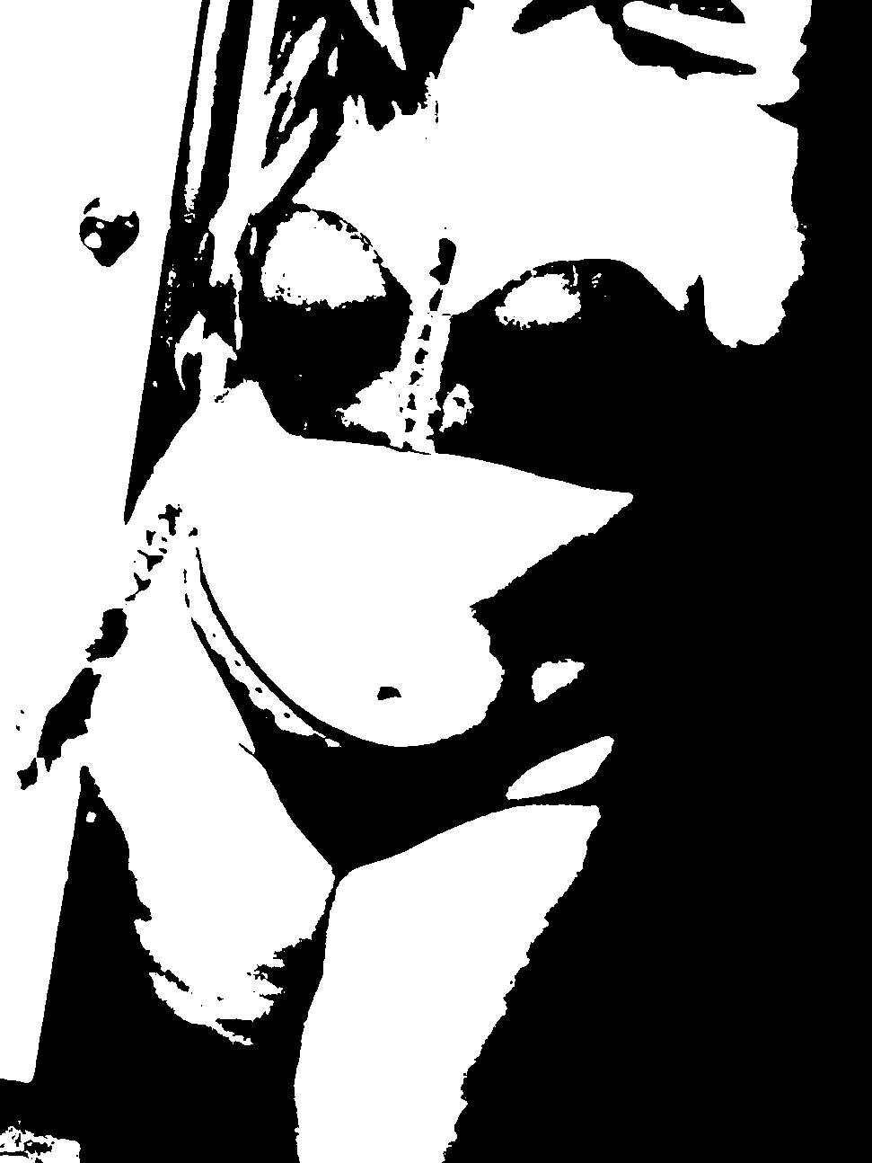 High-contrast portrait with dark sunglasses and a hand at the chin