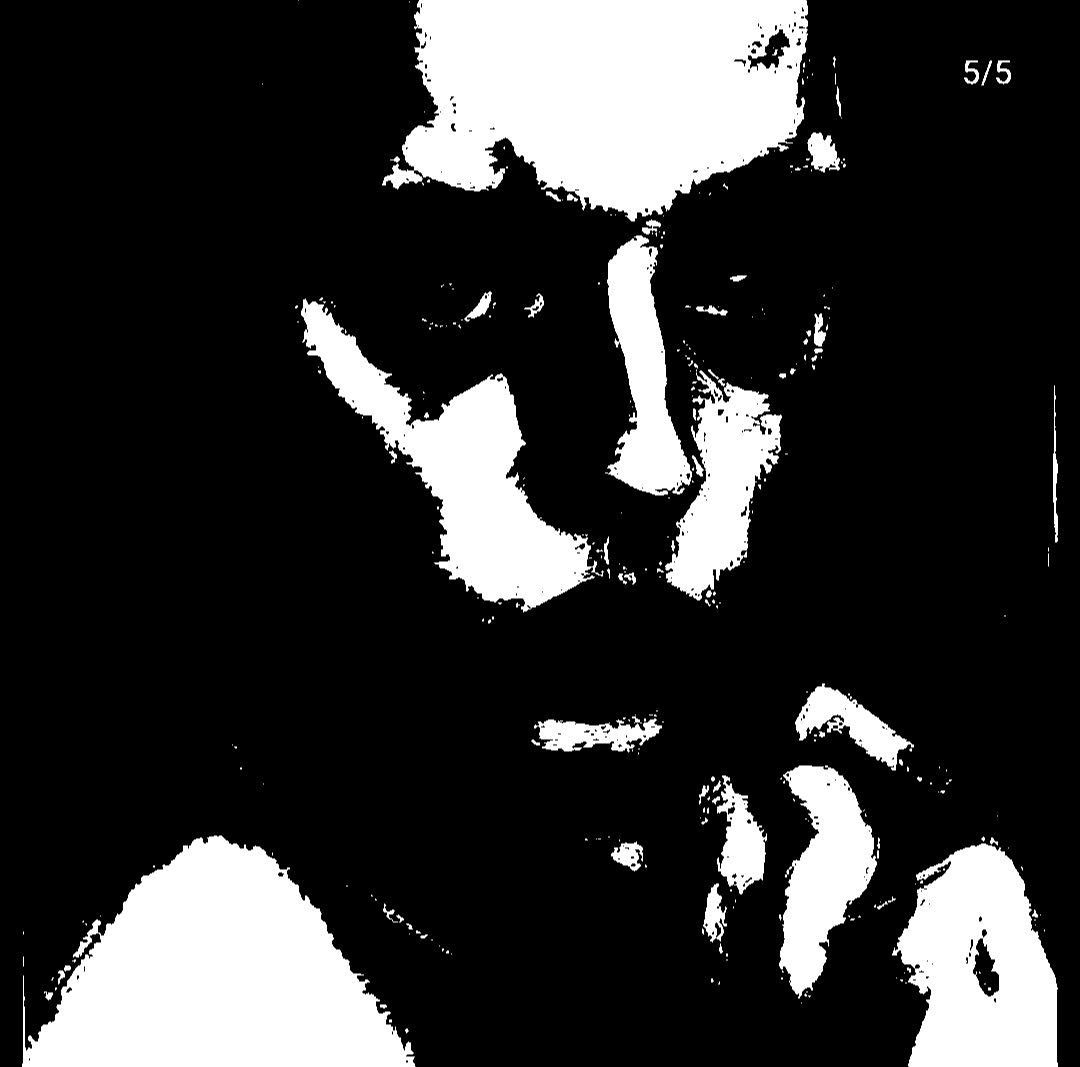Deep-shadow portrait with chin resting on a hand