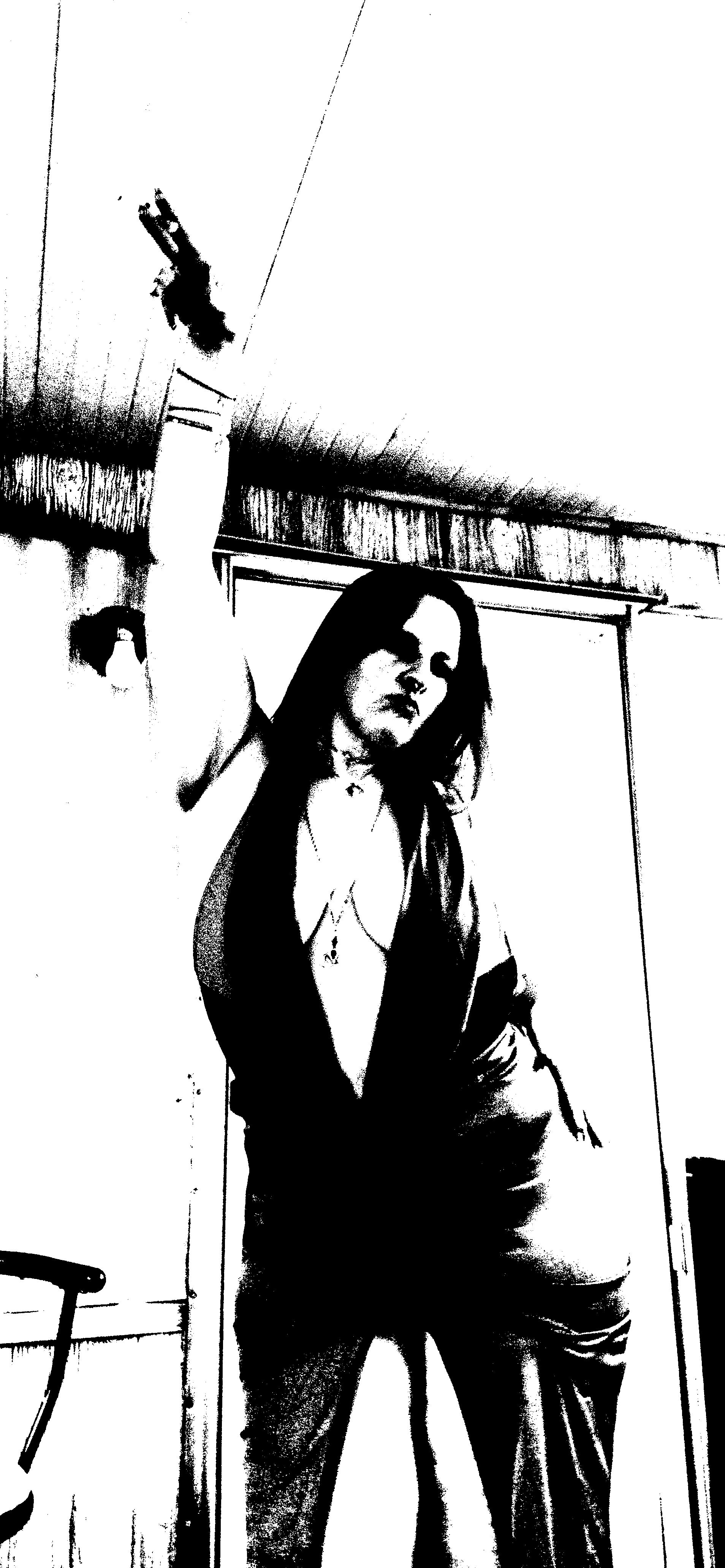 Black-and-white threshold portrait of Starrgazzee reaching upward