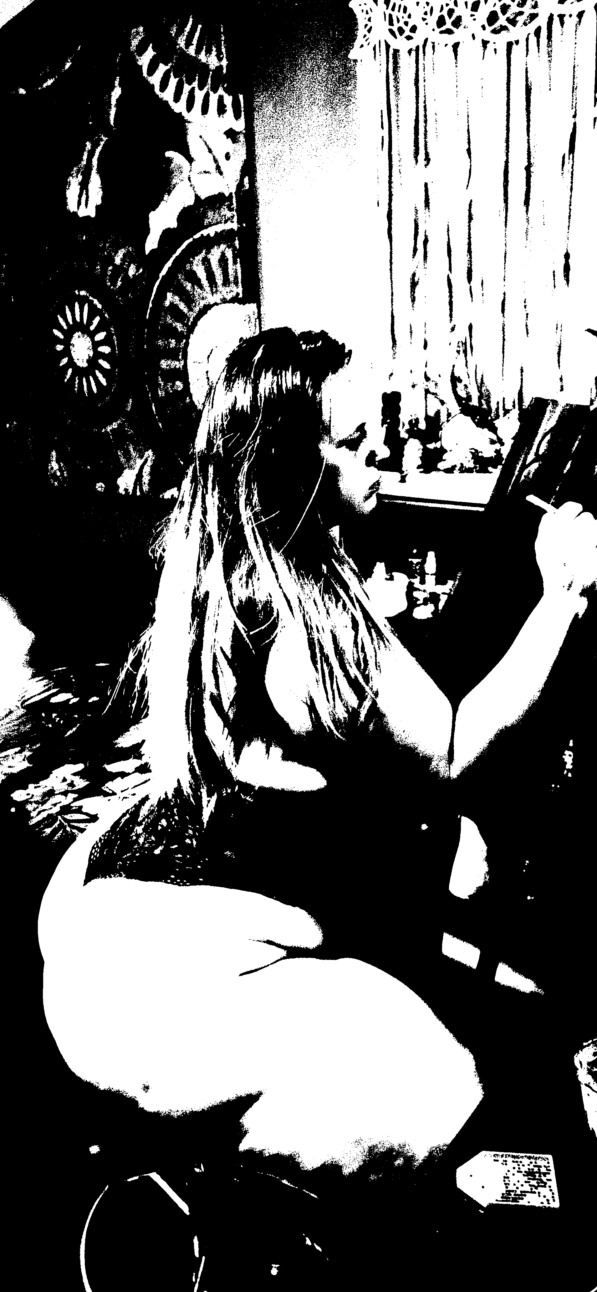Black-and-white threshold image of the artist painting at an easel