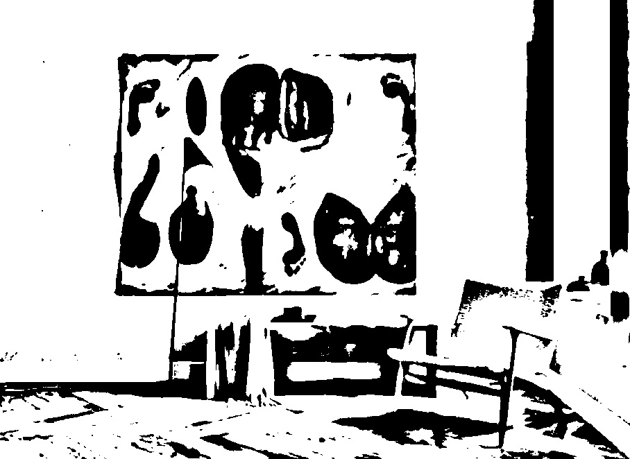 Threshold view of paintings and furnishings in an art studio