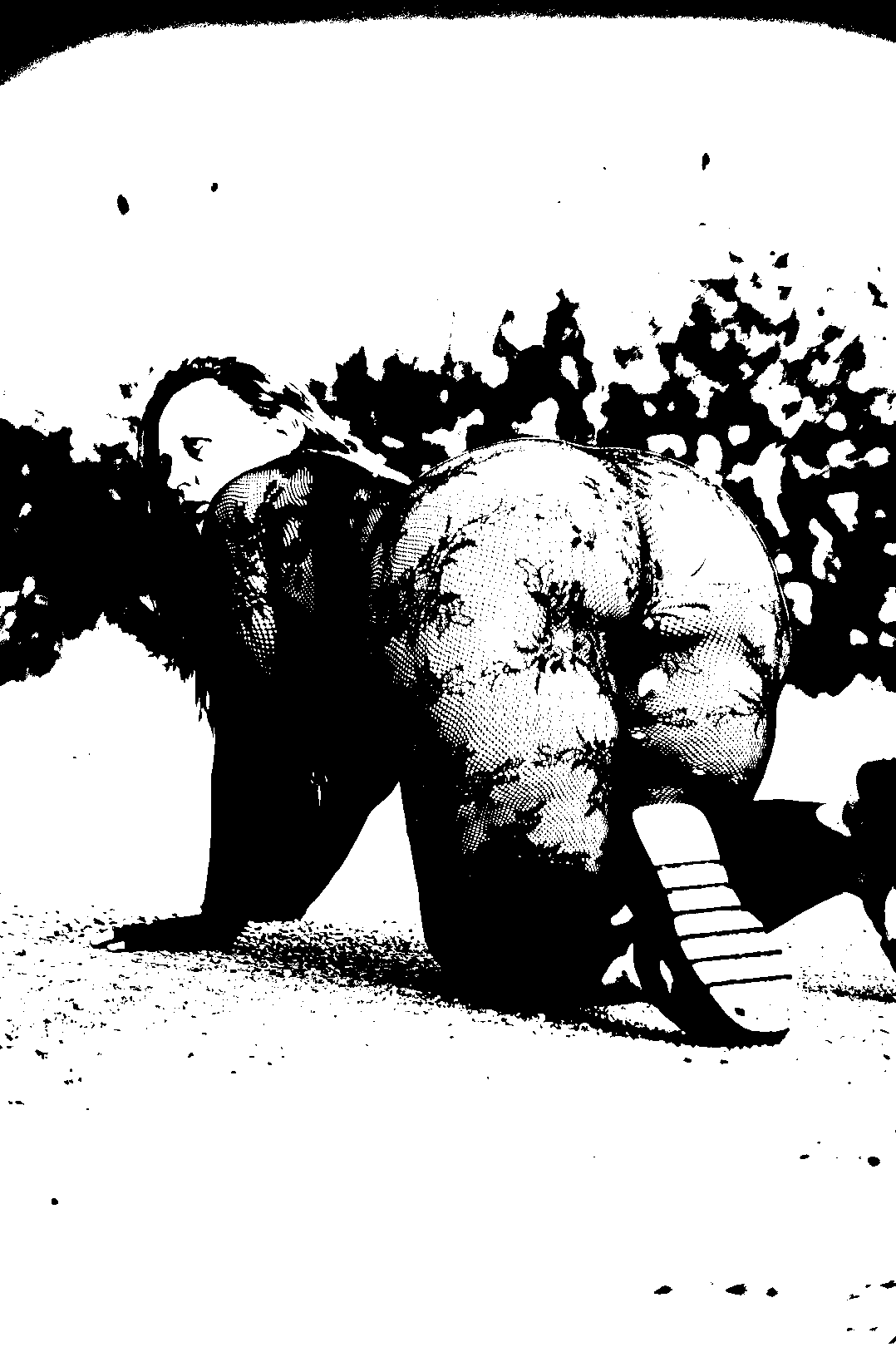 Threshold figure kneeling outdoors, viewed from behind